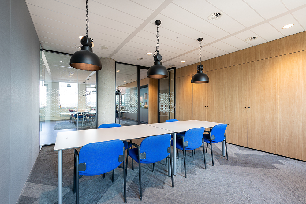 meeting-room-interior-modern-office-with-long-wooden-table-chairs-around-it.jpg